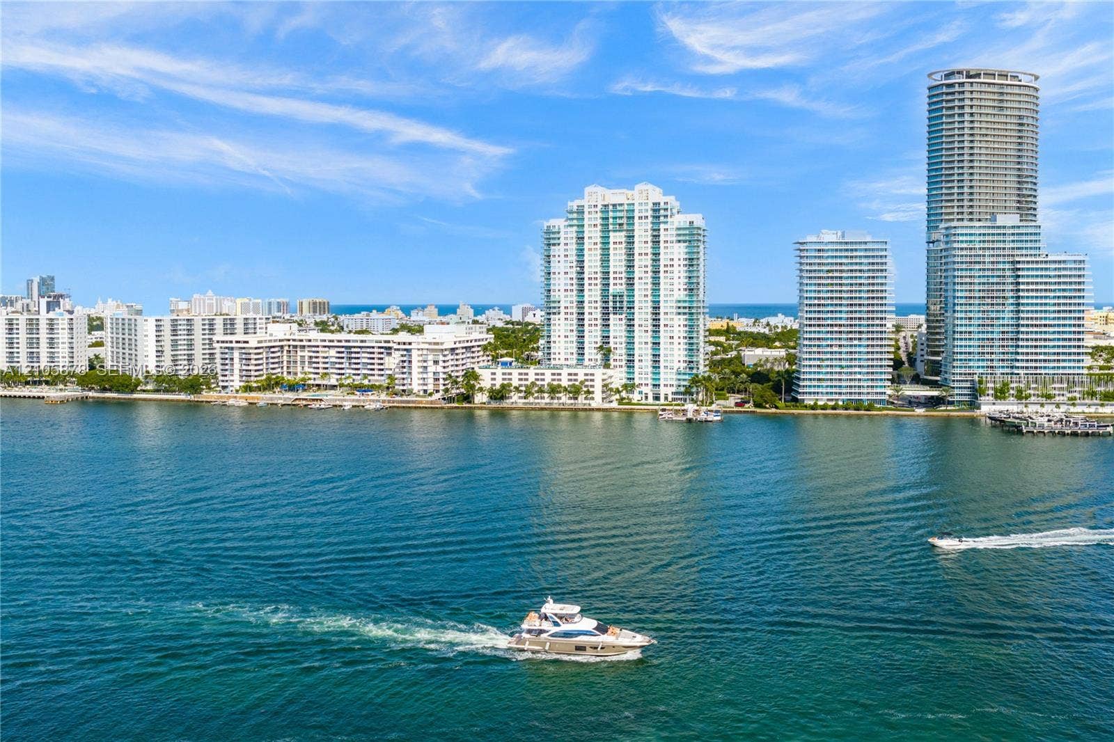 650 West Avenue, #1807, Miami Beach, FL 33139 Waterfront perspective featuring high-rise towers, marine channel, and coastal horizon