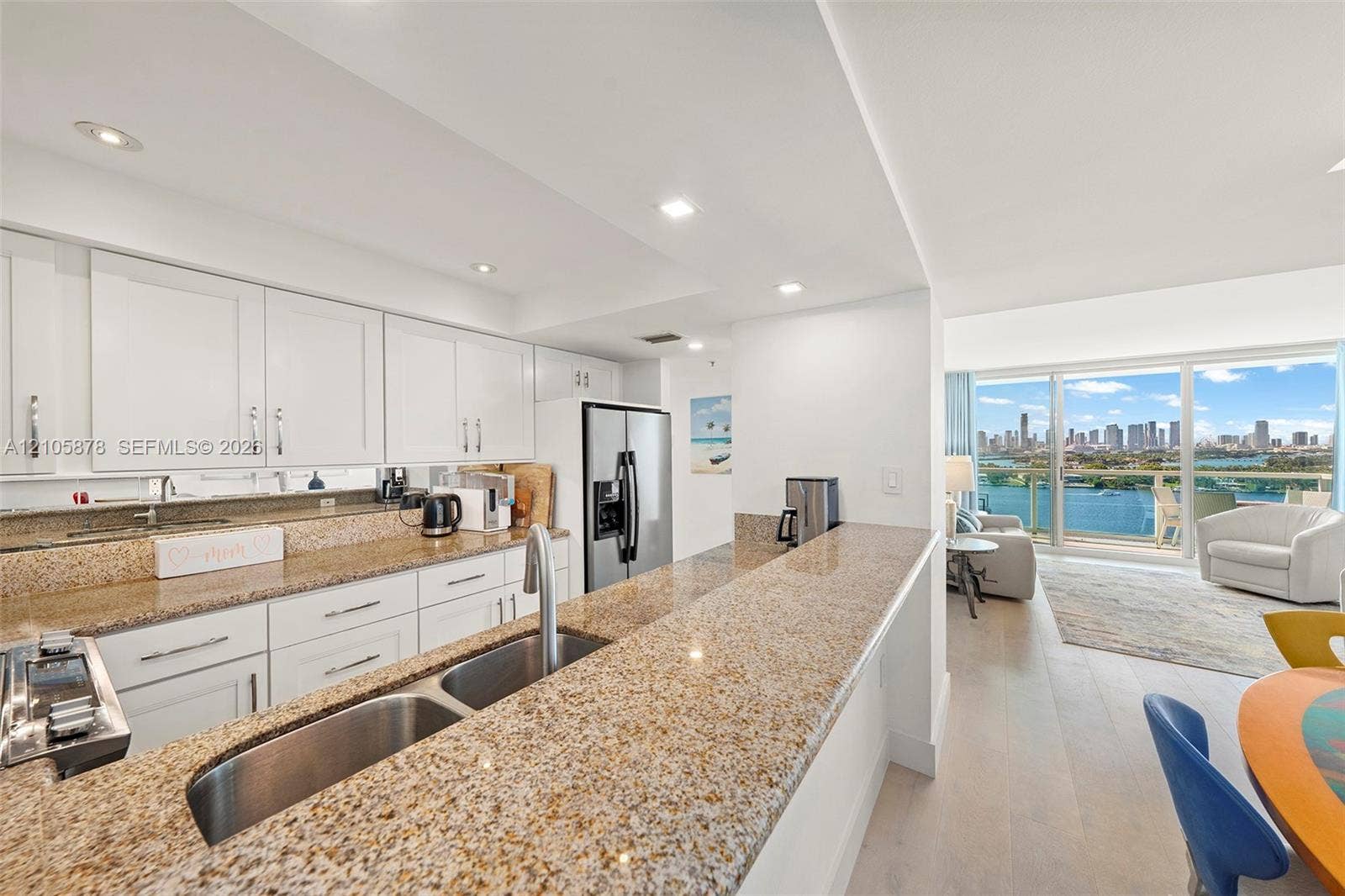650 West Avenue, #1807, Miami Beach, FL 33139 Kitchen featuring white shaker-style cabinetry, stone countertops, stainless steel dual-basin undermount sink, recessed lighting, and wood-finish flooring