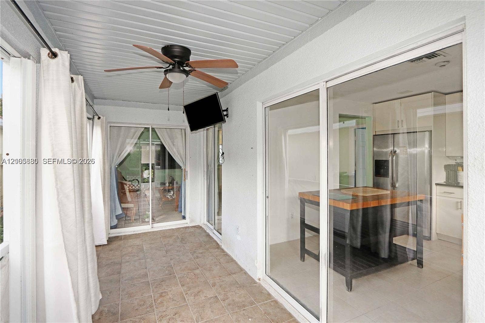 527 SE 21st Drive, Homestead, FL 33033 Covered patio featuring tiled flooring, a ceiling fan, and sliding glass doors