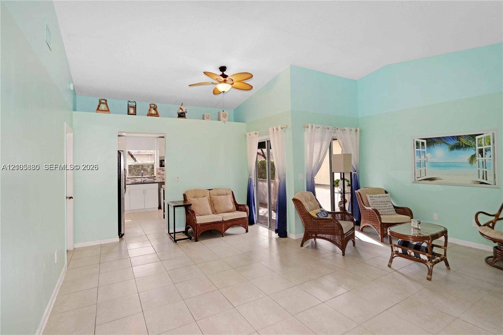527 SE 21st Drive, Homestead, FL 33033 Vaulted ceilings, neutral tile flooring, recessed decorative wall ledge, and ceiling fan with integrated lighting