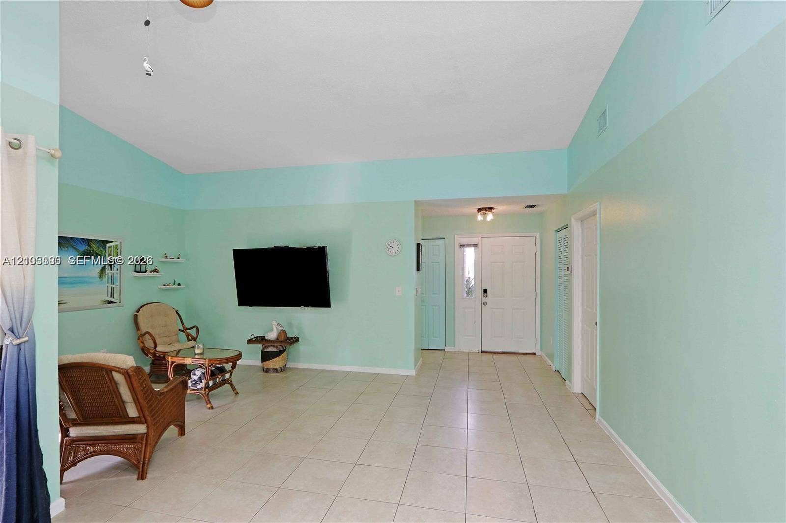 527 SE 21st Drive, Homestead, FL 33033 Vaulted ceilings, neutral tile flooring, and a multi-panel front door with sidelight window