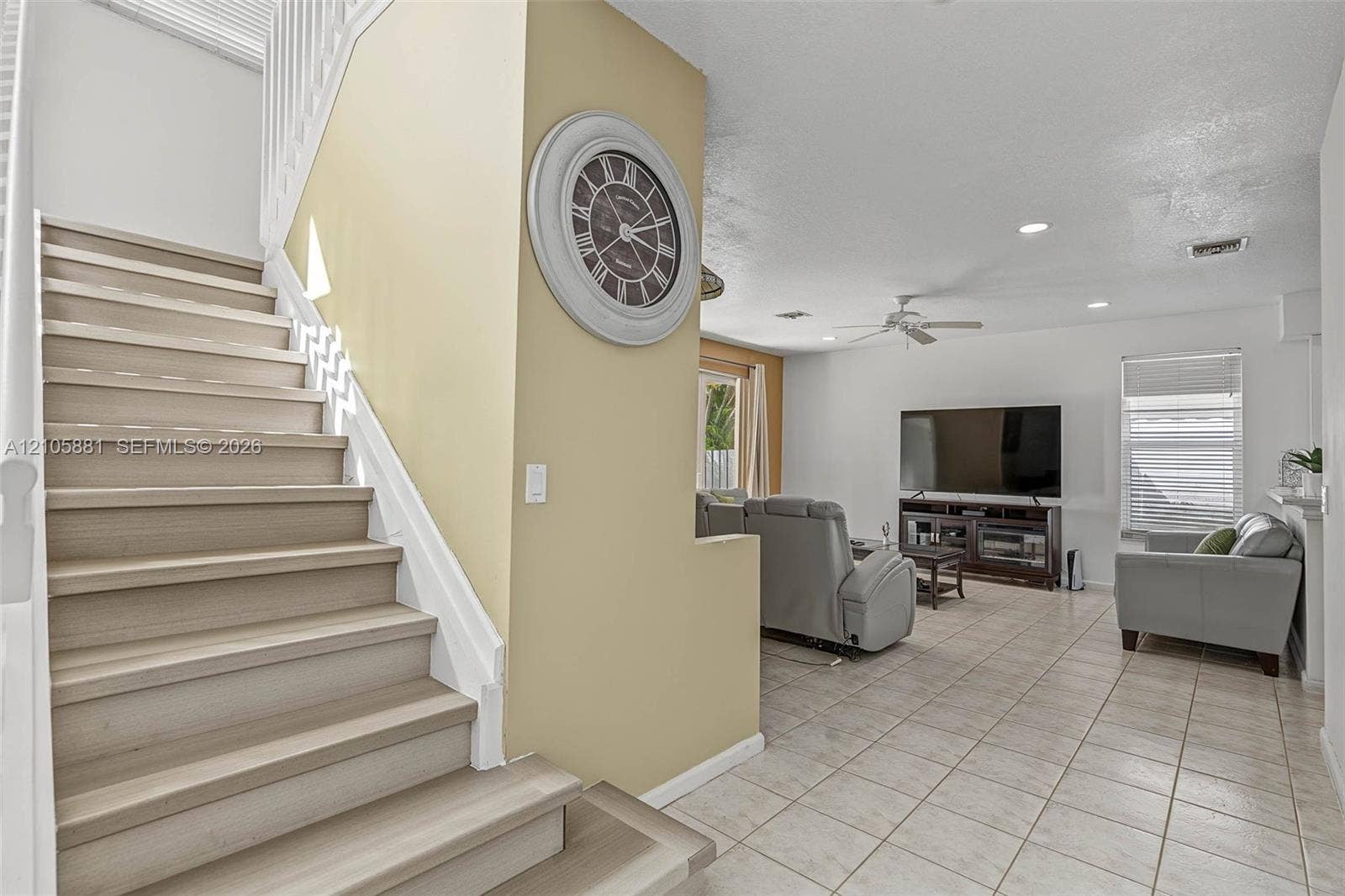 1588 SW 191st Avenue, Pembroke Pines, FL 33029 Staircase with wood-finish treads and white railing, tile flooring, recessed lighting, and ceiling fan