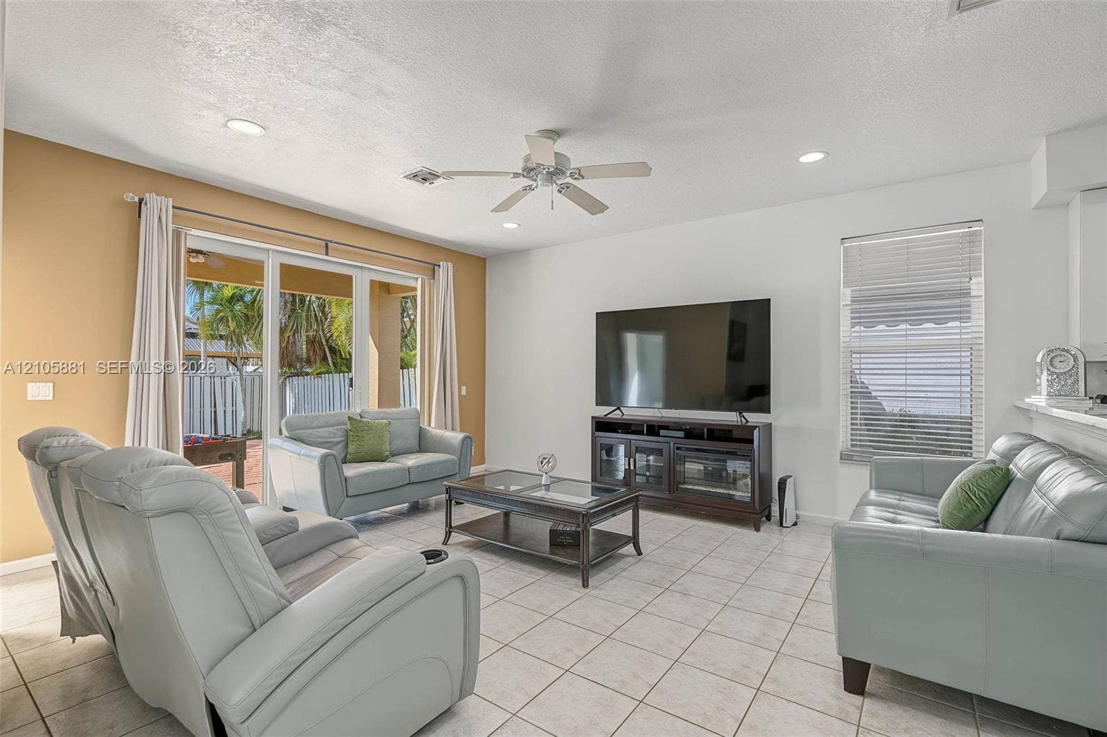 1588 SW 191st Avenue, Pembroke Pines, FL 33029 Living area featuring ceramic tile flooring, recessed lighting, a ceiling fan, and sliding glass doors