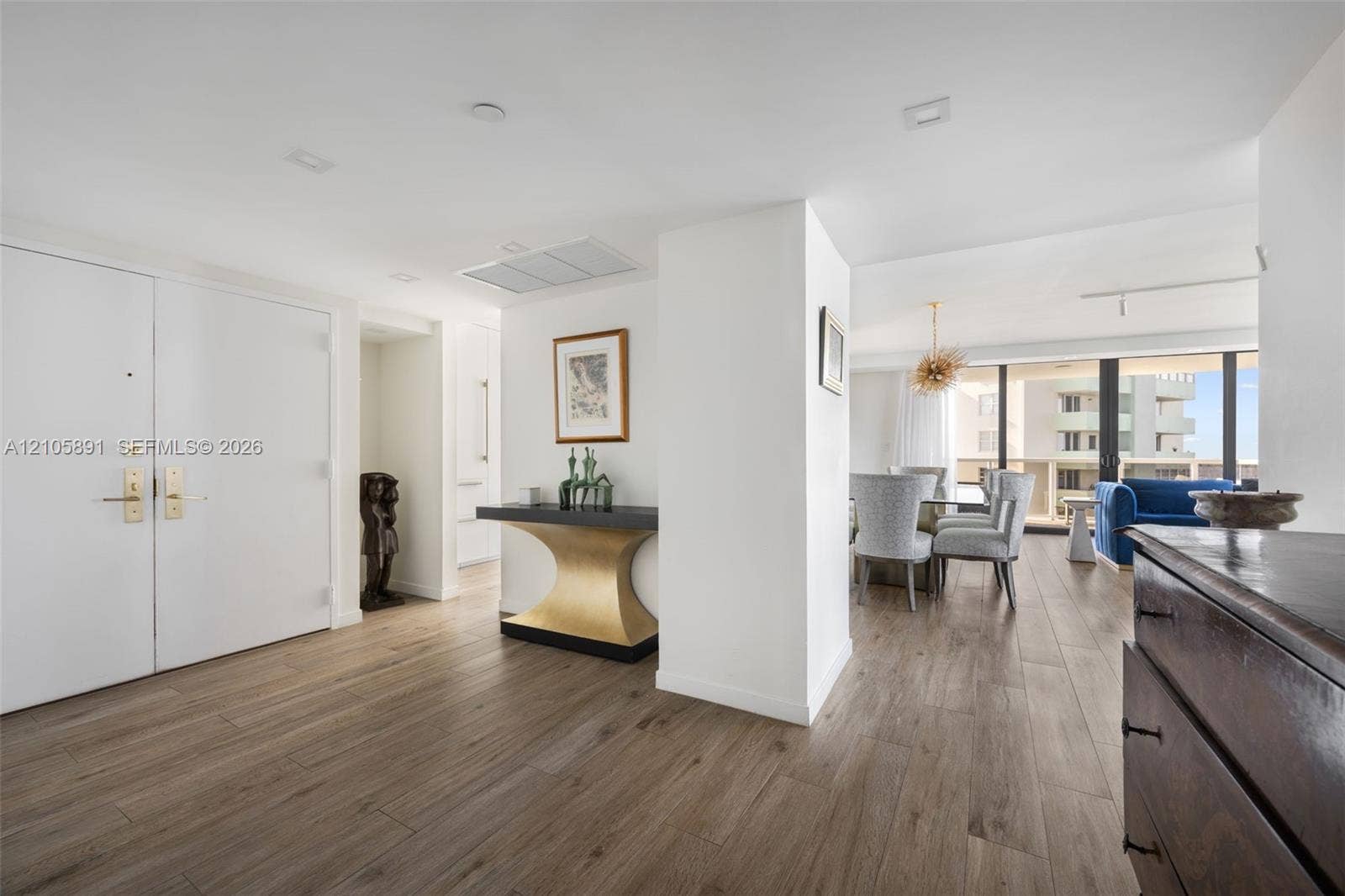 9 Island Avenue, #1215, Miami Beach, FL 33139 Interior space featuring wood-finish flooring, recessed ceiling lighting, and floor-to-ceiling glass sliding doors with access to an exterior balcony
