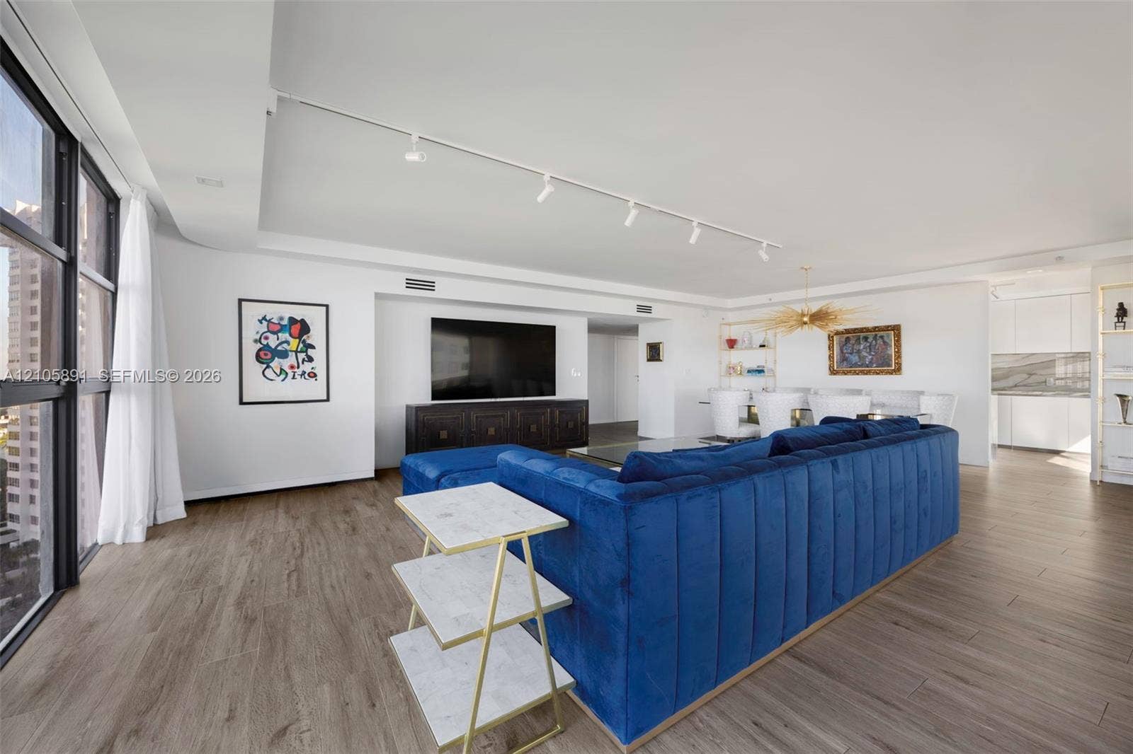 9 Island Avenue, #1215, Miami Beach, FL 33139 Expansive living area featuring floor-to-ceiling windows, wood-finish flooring, and recessed track lighting