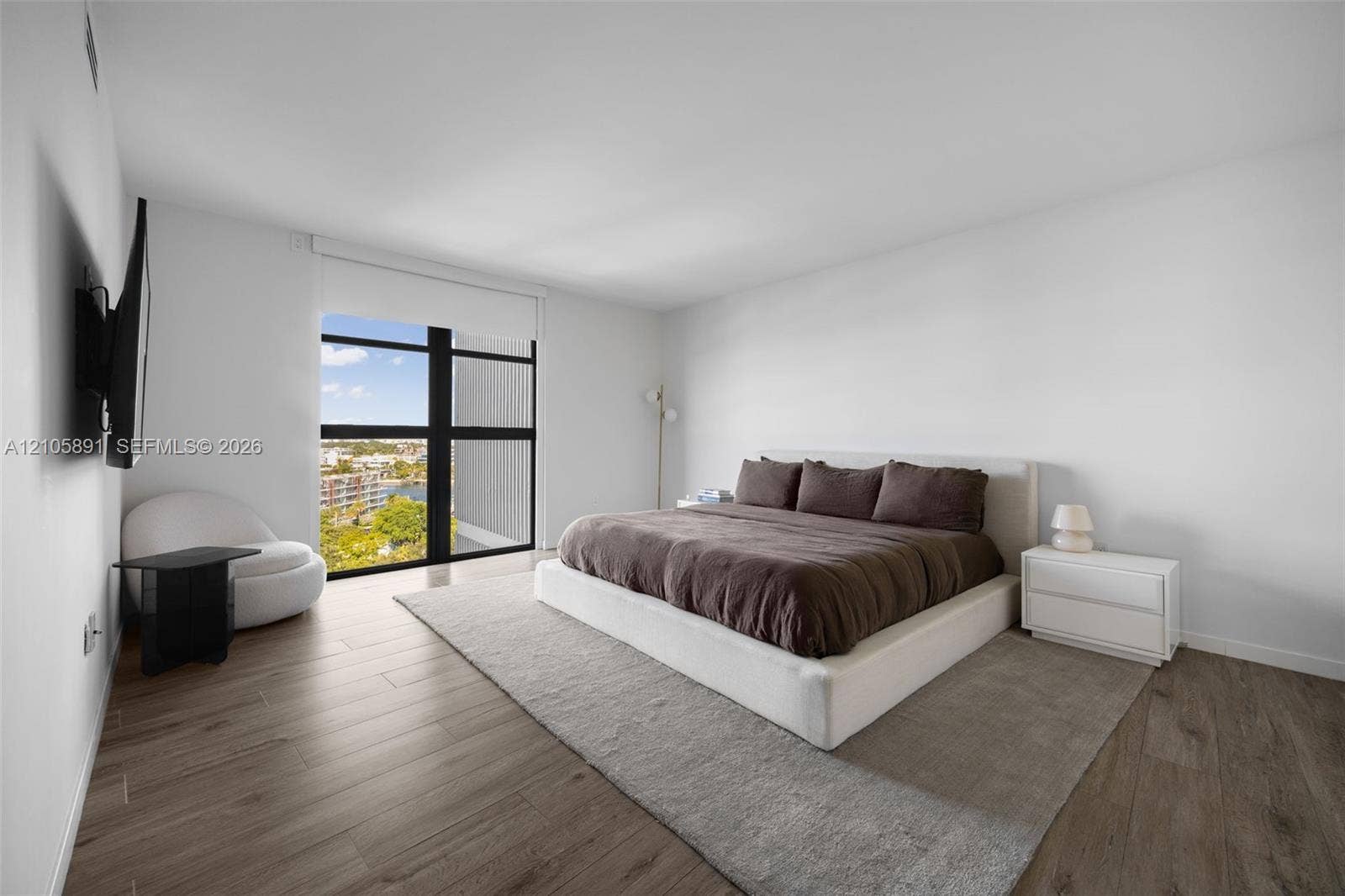 9 Island Avenue, #1215, Miami Beach, FL 33139 Floor-to-ceiling windows with dark framing, wood-finish flooring, and high ceilings