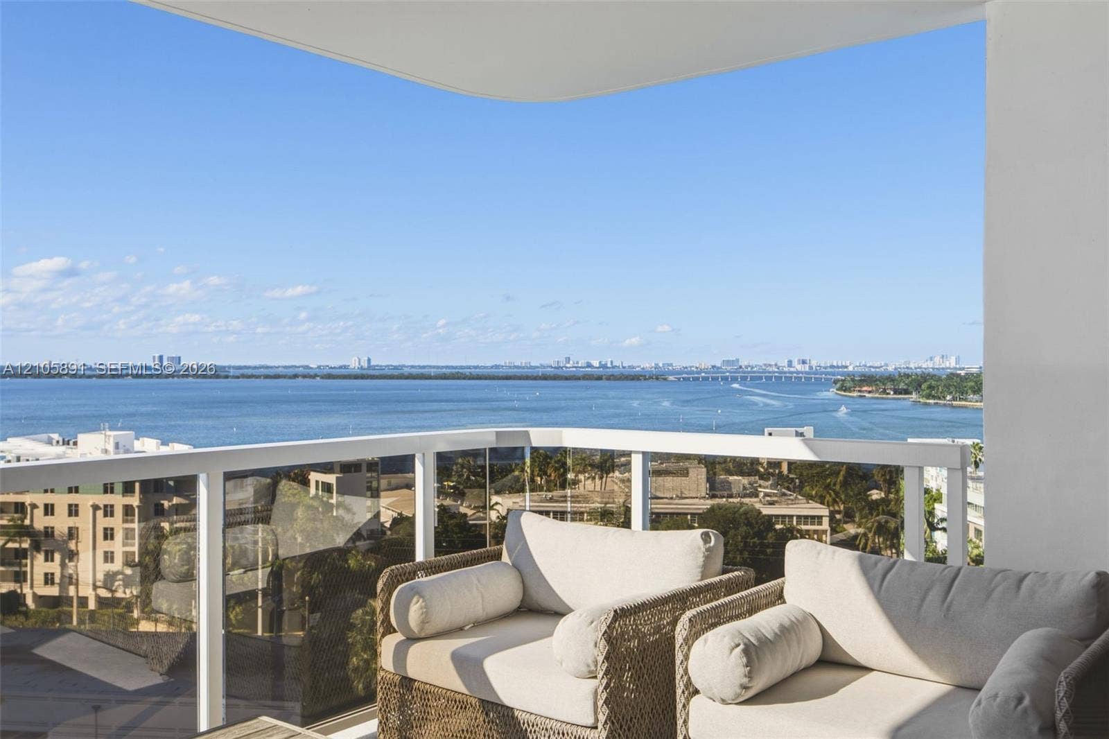 9 Island Avenue, #1215, Miami Beach, FL 33139 Private balcony featuring a white metal railing with glass panels and expansive water surroundings
