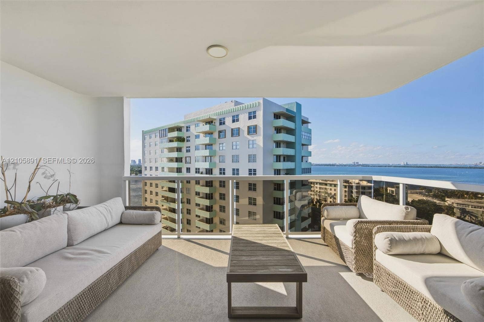 9 Island Avenue, #1215, Miami Beach, FL 33139 Covered balcony featuring a concrete floor, glass panel railing, and ceiling-mounted lighting