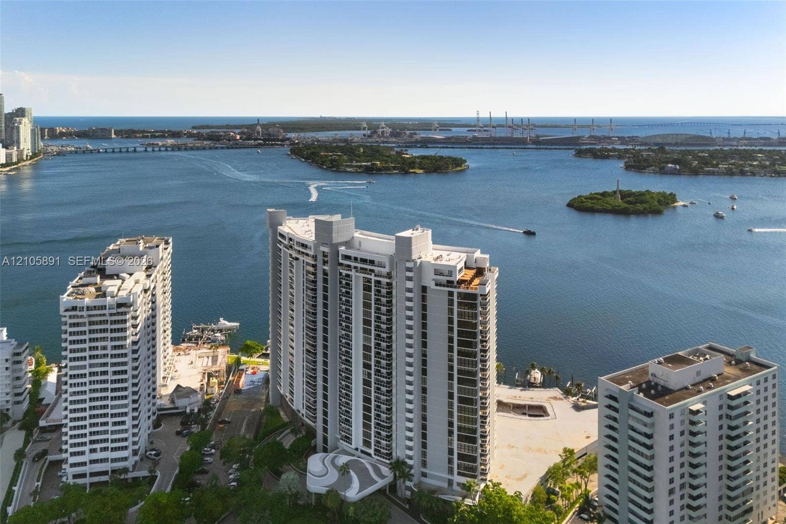 9 Island Avenue, #1215, Miami Beach, FL 33139 High-rise residential building featuring exterior balconies, a circular porte-cochre, and coastal surroundings