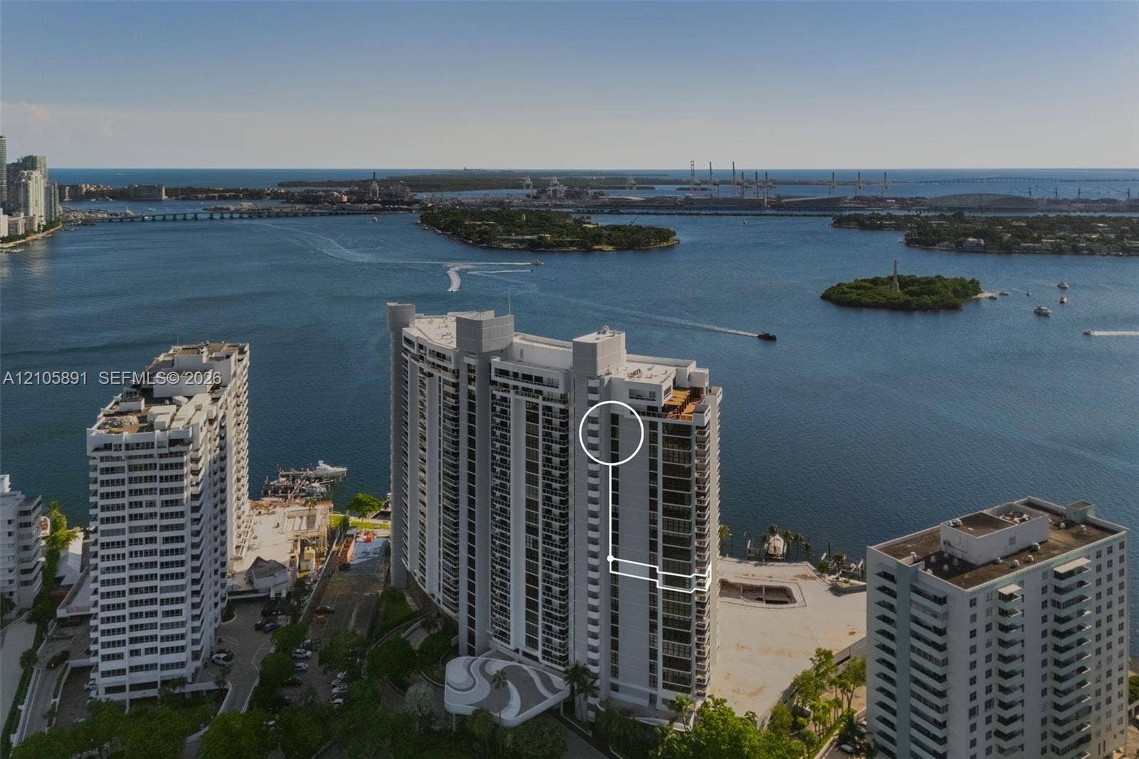 9 Island Avenue, #1215, Miami Beach, FL 33139 High-rise residential building featuring expansive floor-to-ceiling windows, private balconies, and waterfront positioning