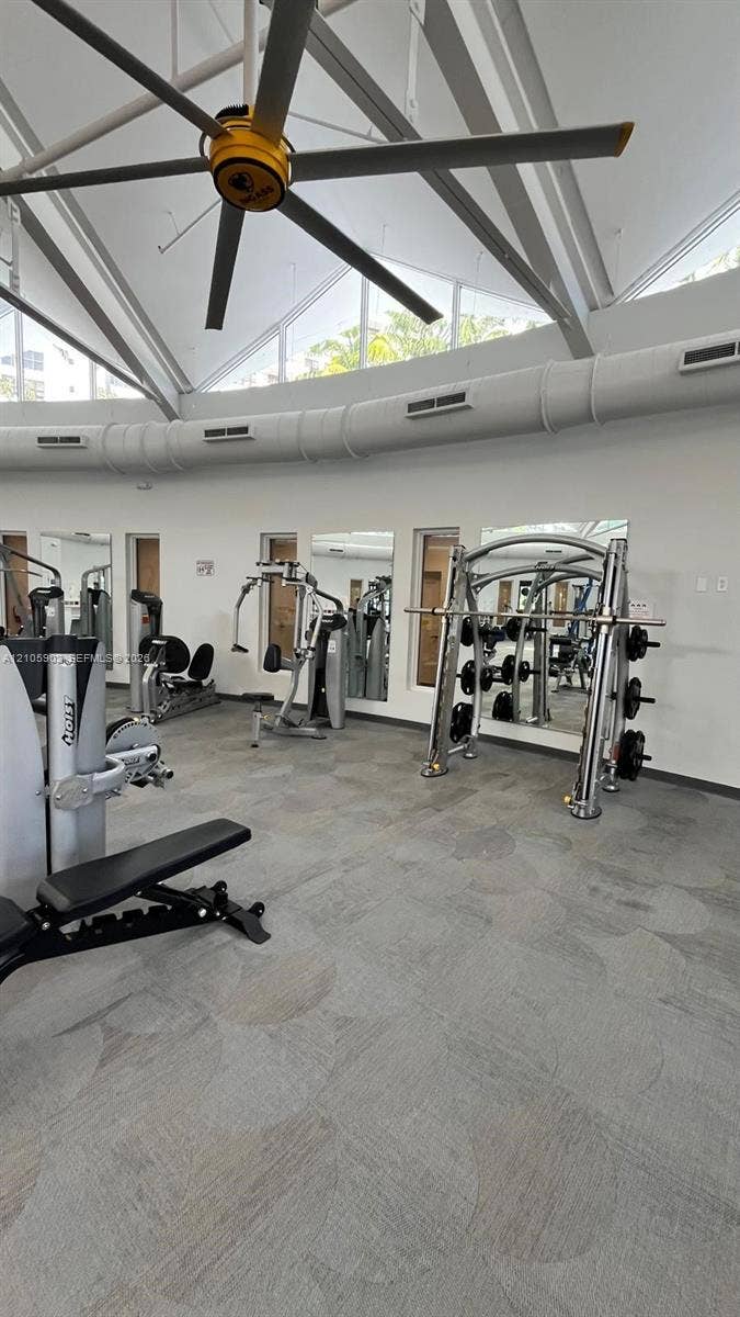600 Three Islands Boulevard, #913, Hallandale Beach, Hallandale Beach, FL 33009 Vaulted ceiling with oversized industrial ceiling fan, clerestory windows, wall-to-wall mirrors, and resilient commercial-grade flooring