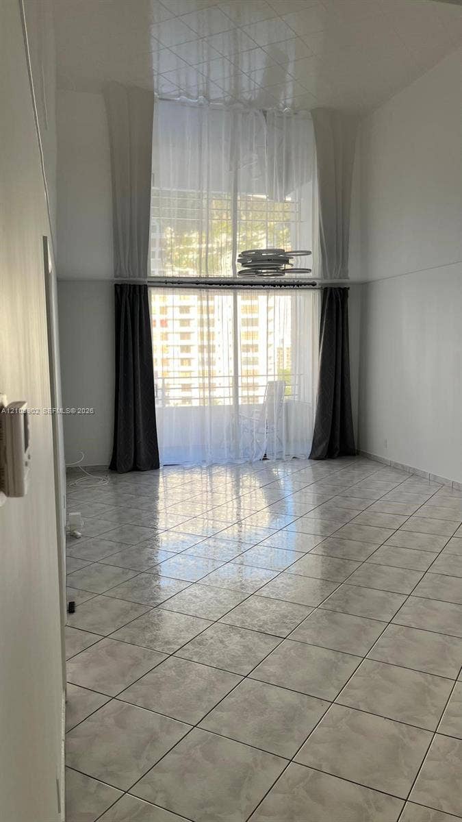 600 Three Islands Boulevard, #913, Hallandale Beach, Hallandale Beach, FL 33009 High ceilings, light-reflective tile flooring, and floor-to-ceiling glass paneling