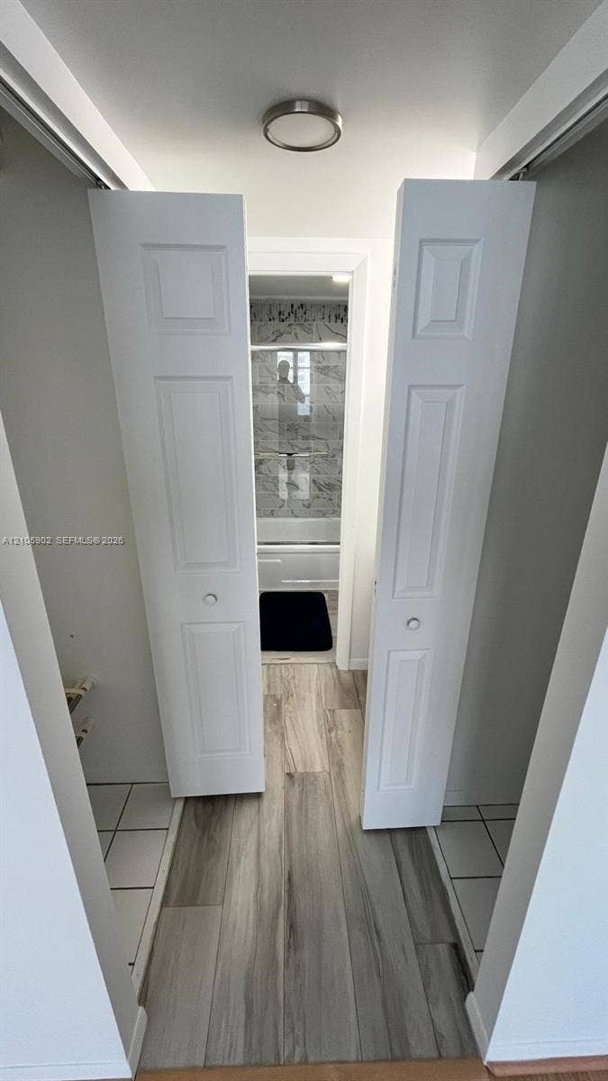 600 Three Islands Boulevard, #913, Hallandale Beach, Hallandale Beach, FL 33009 White bi-fold doors, wood-finish flooring, and a flush-mount ceiling fixture