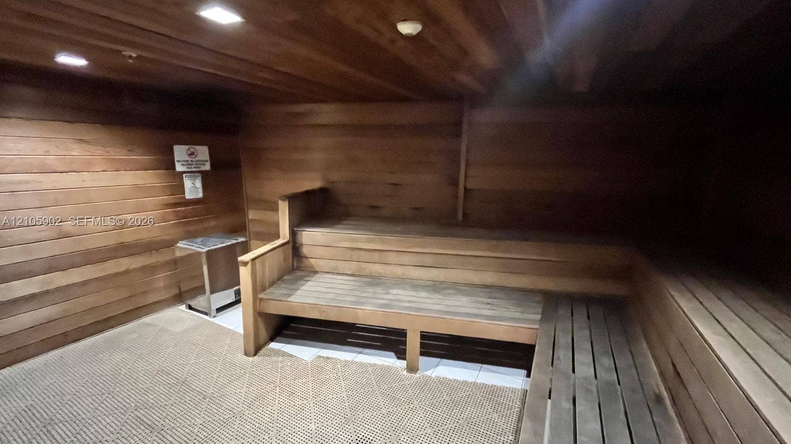 600 Three Islands Boulevard, #913, Hallandale Beach, Hallandale Beach, FL 33009 Sauna featuring tongue-and-groove wood paneling, multi-tiered built-in wood bench seating, integrated recessed lighting, and a metal heating unit