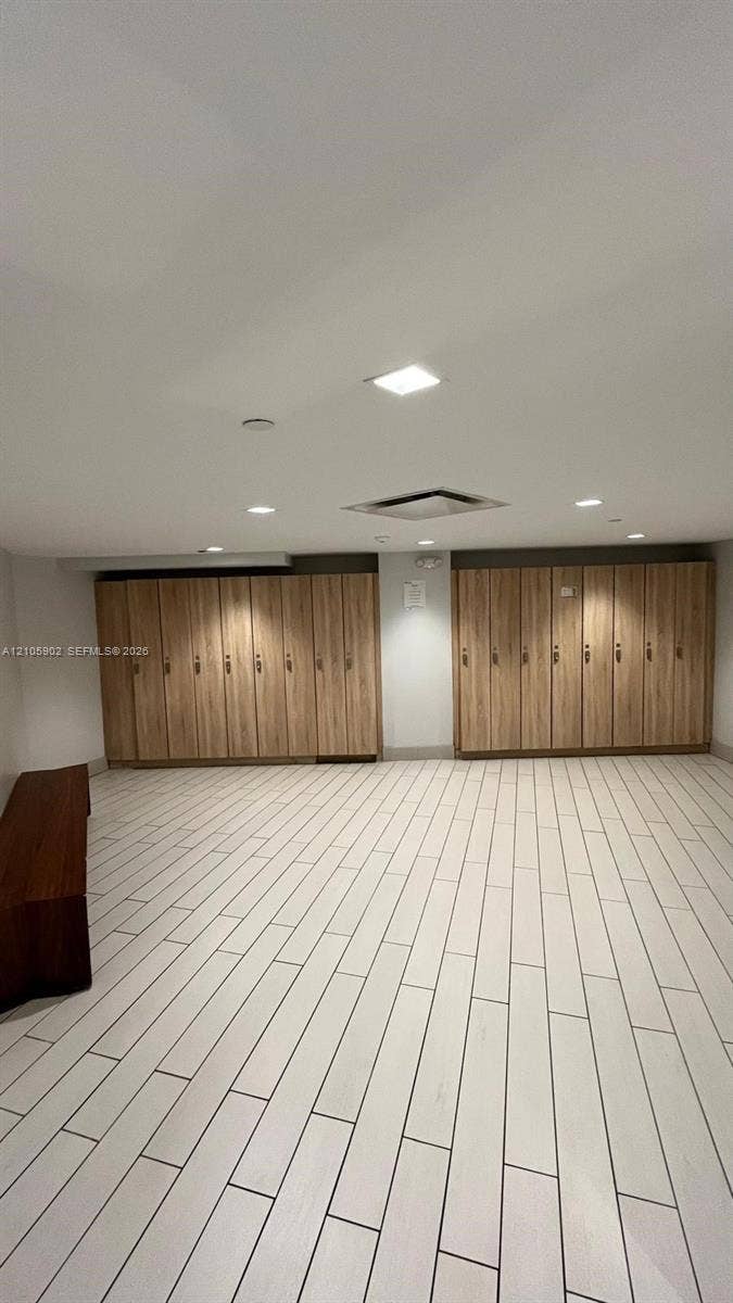 600 Three Islands Boulevard, #913, Hallandale Beach, Hallandale Beach, FL 33009 Room featuring extensive wood-finish cabinetry, recessed ceiling lighting, and light-toned ceramic tile flooring