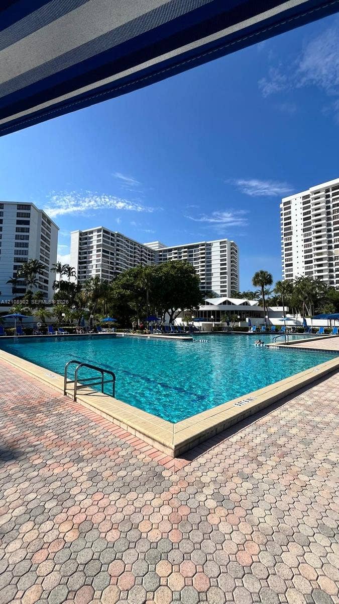 600 Three Islands Boulevard, #913, Hallandale Beach, Hallandale Beach, FL 33009 Swimming pool with metal handrails, surrounded by concrete paver decking