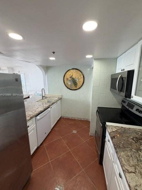 7601 E Treasure Drive, #2417, North Bay Village, North Bay Village, FL 33141 Kitchen featuring white cabinetry, stone-finish countertops, stainless steel appliances, ceramic tile flooring, and recessed lighting