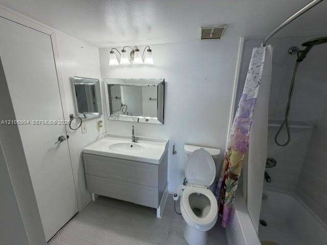 7601 E Treasure Drive, #2417, North Bay Village, North Bay Village, FL 33141 Bathroom featuring a gray vanity with an integrated sink, a beveled-edge mirror, a three-light vanity fixture, and a shower-tub combination with a handheld showerhead