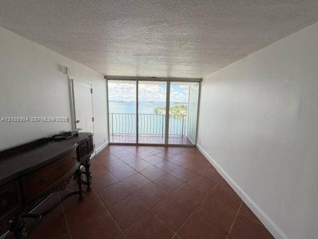 7601 E Treasure Drive, #2417, North Bay Village, North Bay Village, FL 33141 Ceramic tile flooring, floor-to-ceiling glass sliding doors, and a private balcony featuring a metal railing
