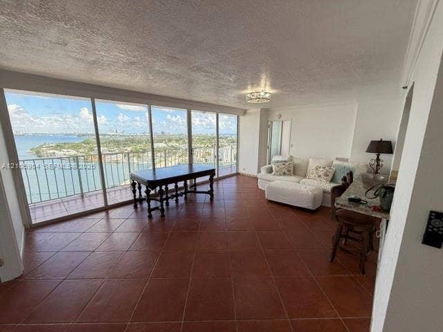 7601 E Treasure Drive, #2417, North Bay Village, North Bay Village, FL 33141 Open-concept interior featuring wall-to-wall floor-to-ceiling glass sliding doors, ceramic tile flooring, and a private balcony with water scenery