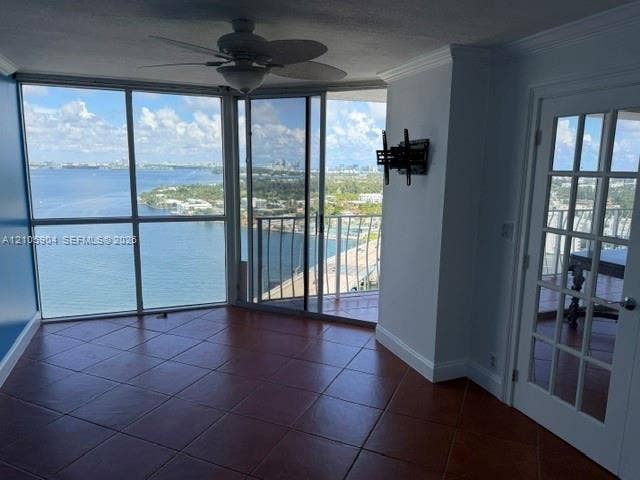 7601 E Treasure Drive, #2417, North Bay Village, North Bay Village, FL 33141 Floor-to-ceiling windows featuring panoramic water scenery, large-format tile flooring, sliding glass doors, a ceiling fan, and a French-style door
