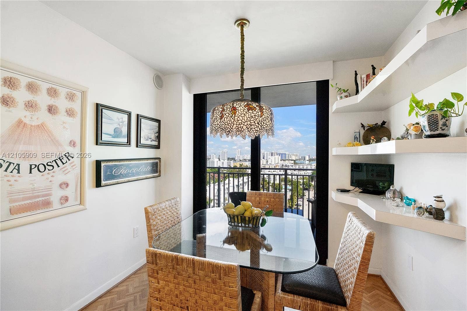 Dining area featuring floor-to-ceiling windows, built-in floating shelves, parquet flooring, and an ornamental pendant light fixture