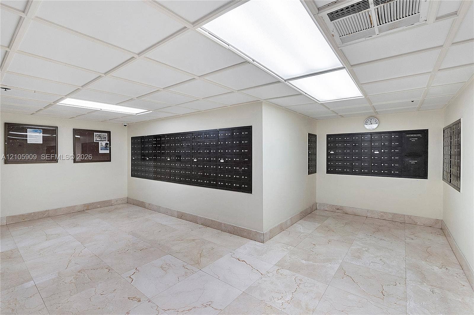 Mailroom featuring recessed lighting, tiled flooring, and wall-mounted metal mailbox units