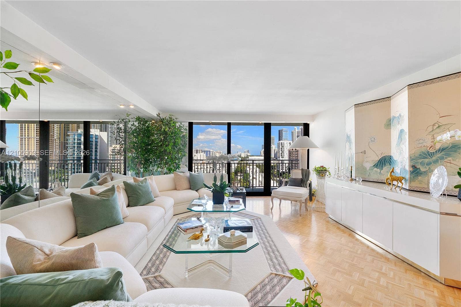 Floor-to-ceiling windows, parquet flooring, mirrored wall accents, and custom built-in cabinetry