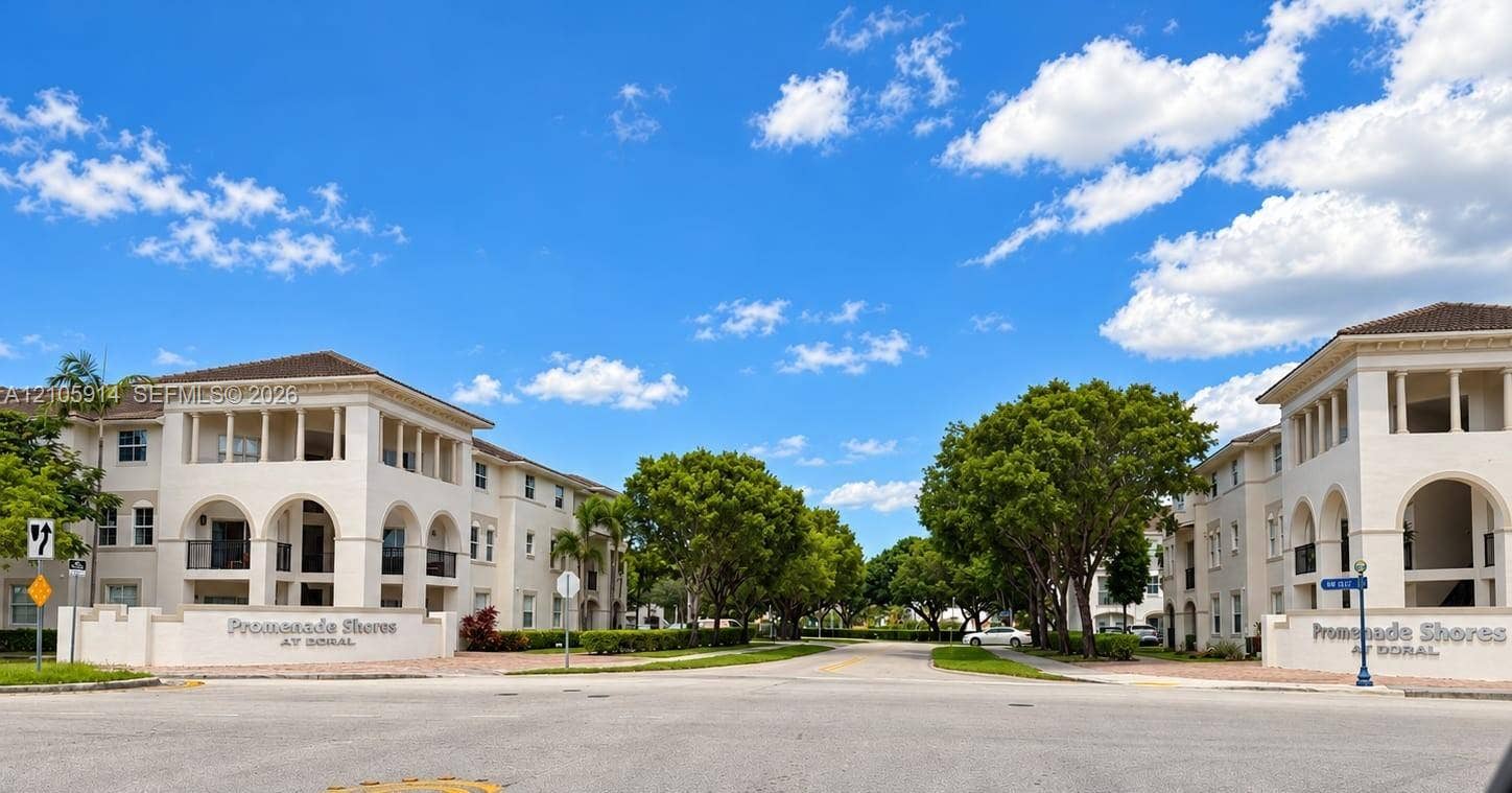 11102 NW 83rd Street, #216, Doral, FL 33178 Multi-story residential complex featuring Mediterranean-inspired architectural elements, arched exterior colonnades, stucco facades, and mature landscaping