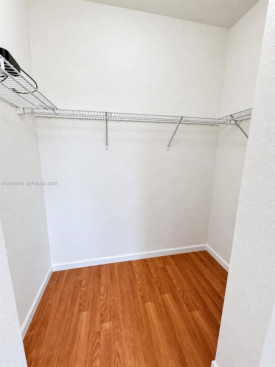 11102 NW 83rd Street, #216, Doral, FL 33178 Storage area featuring wood-finish flooring and integrated wire shelving
