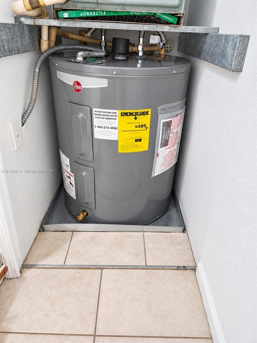 11102 NW 83rd Street, #216, Doral, FL 33178 Electric water heater unit situated within a tiled containment pan