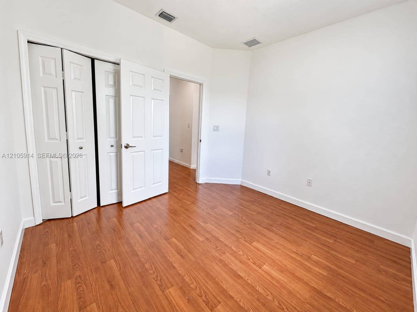 11102 NW 83rd Street, #216, Doral, FL 33178 Neutral wall palette with wood-finish flooring and paneled bi-fold closet doors