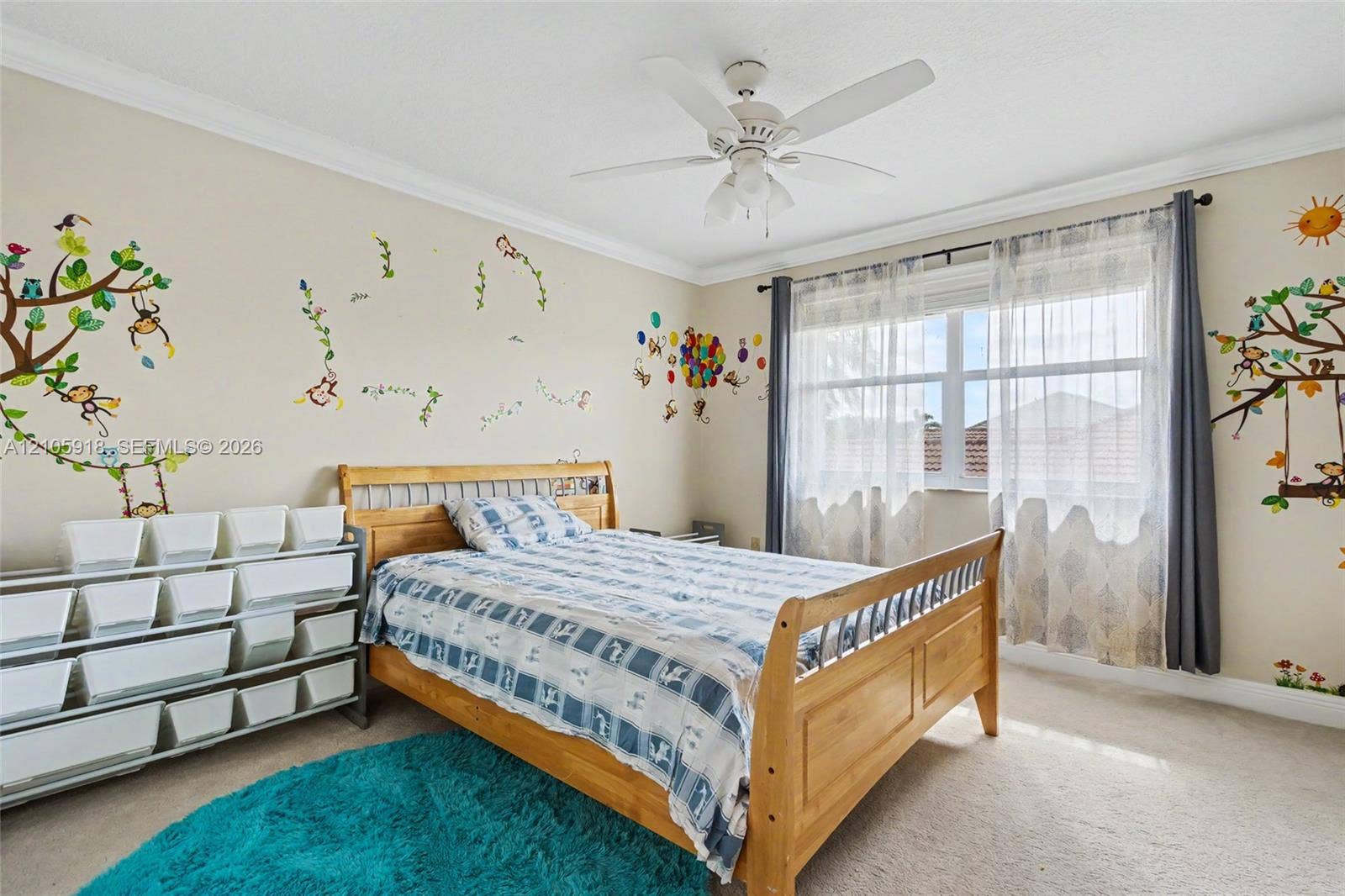 Neutral-toned room featuring crown molding, carpeting, and a central ceiling fan with integrated lighting