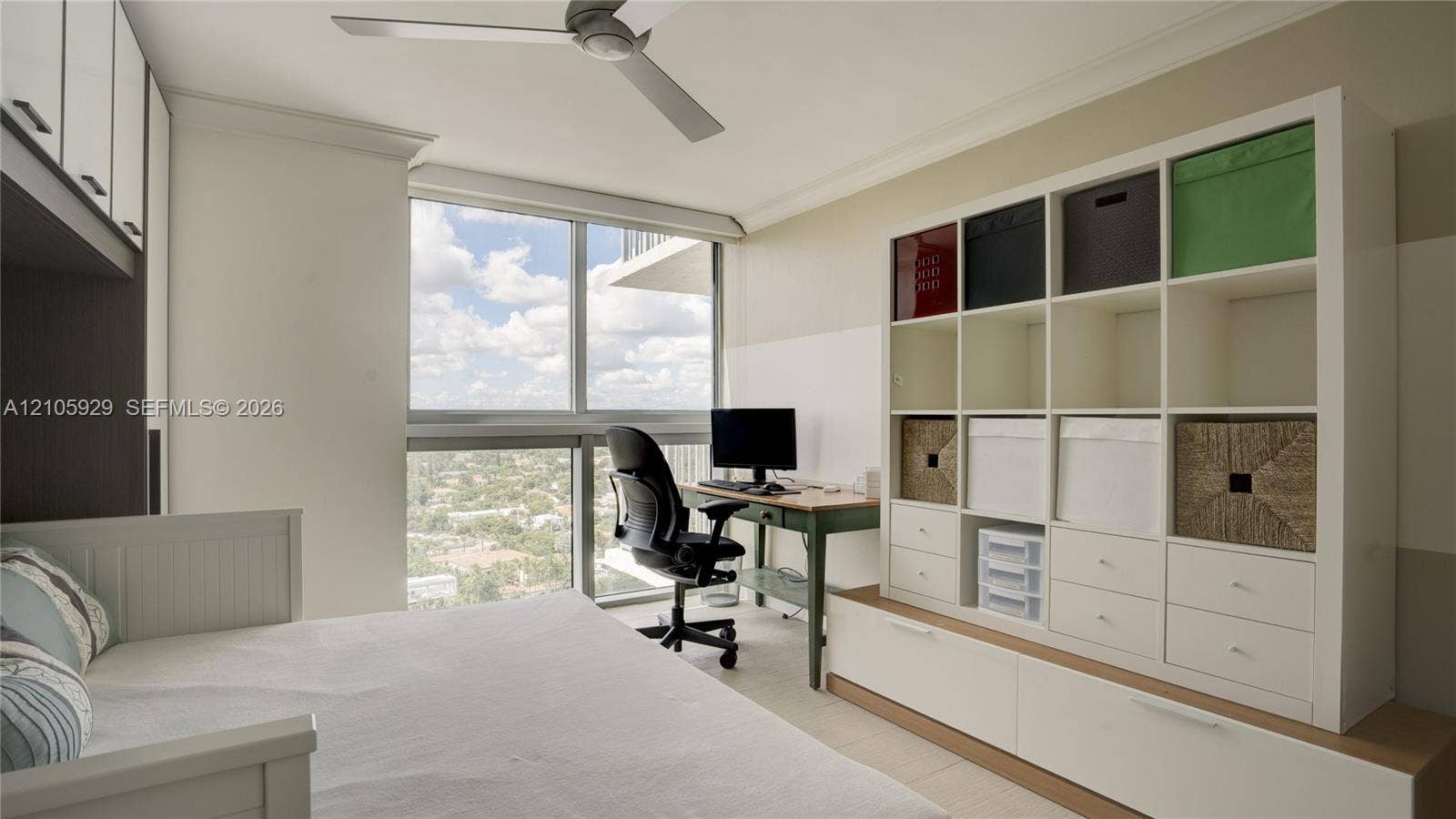 2655 Collins Avenue, #2301, Miami Beach, FL 33140 Floor-to-ceiling windows, built-in floor-to-ceiling white cabinetry, and a ceiling-mounted fan