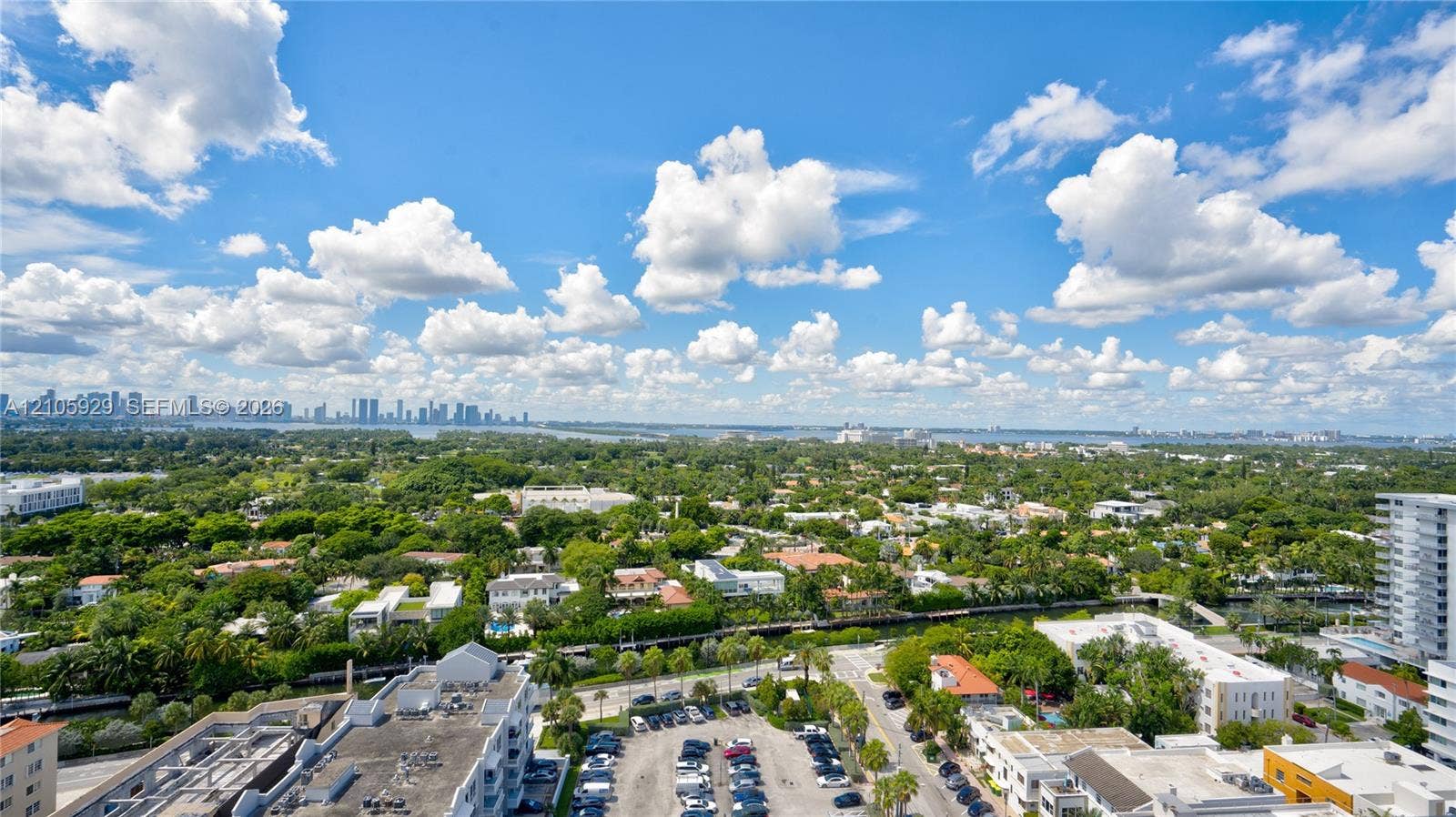 2655 Collins Avenue, #2301, Miami Beach, FL 33140 Elevated aerial perspective featuring expansive cityscape and horizon, lush canopy of mature trees, and waterfront canal elements
