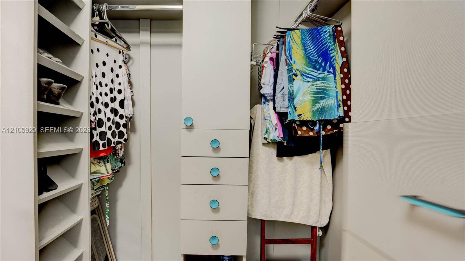 2655 Collins Avenue, #2301, Miami Beach, FL 33140 Walk-in closet featuring custom built-in cabinetry, floor-to-ceiling shelving, integrated drawer stack, and horizontal hanging rods