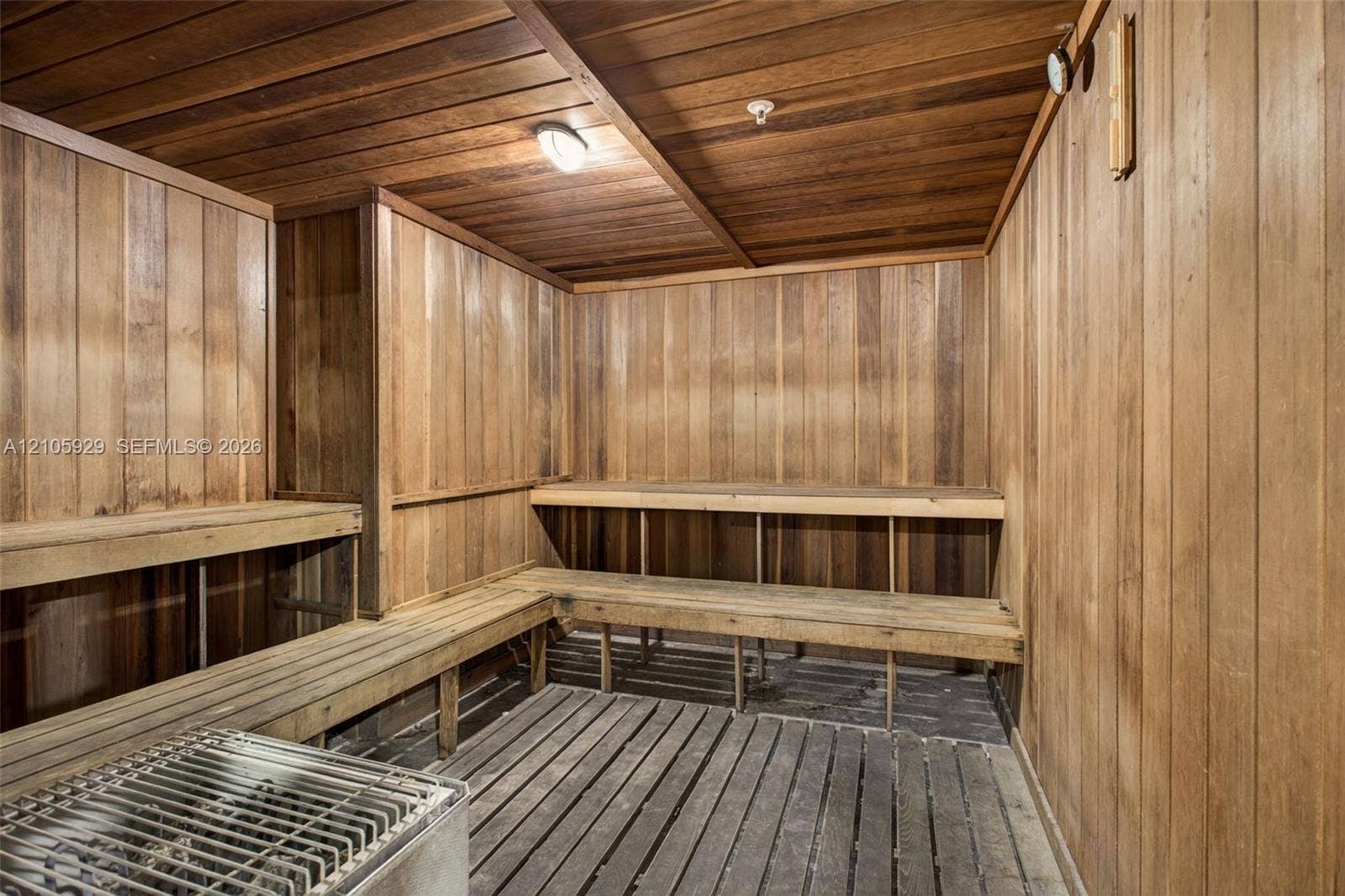 2655 Collins Avenue, #2301, Miami Beach, FL 33140 Sauna featuring tongue-and-groove wood wall paneling, multi-level wood bench seating, wood slat flooring, and an integrated heating unit