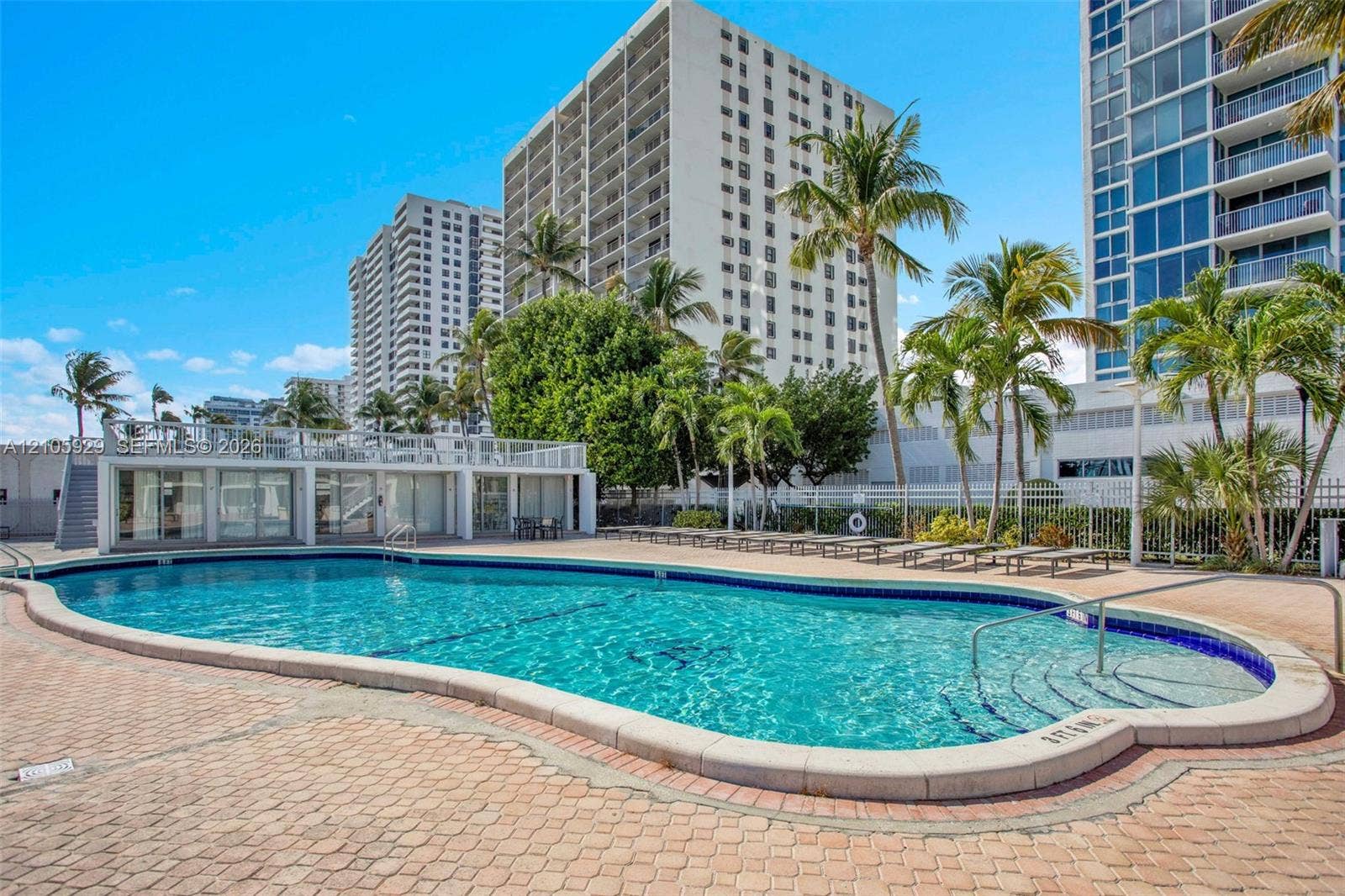 2655 Collins Avenue, #2301, Miami Beach, FL 33140 Swimming pool with paved surround, integrated stairs, and metal perimeter fencing