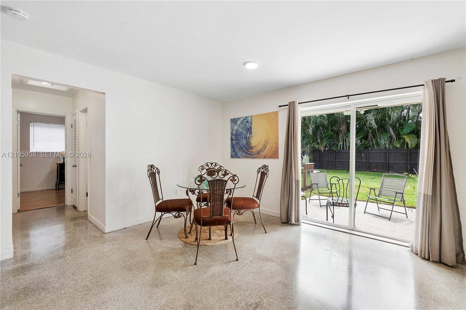 8310 NW 10th Street, Pembroke Pines, FL 33024 Polished concrete flooring, sliding glass door, and neutral wall tones