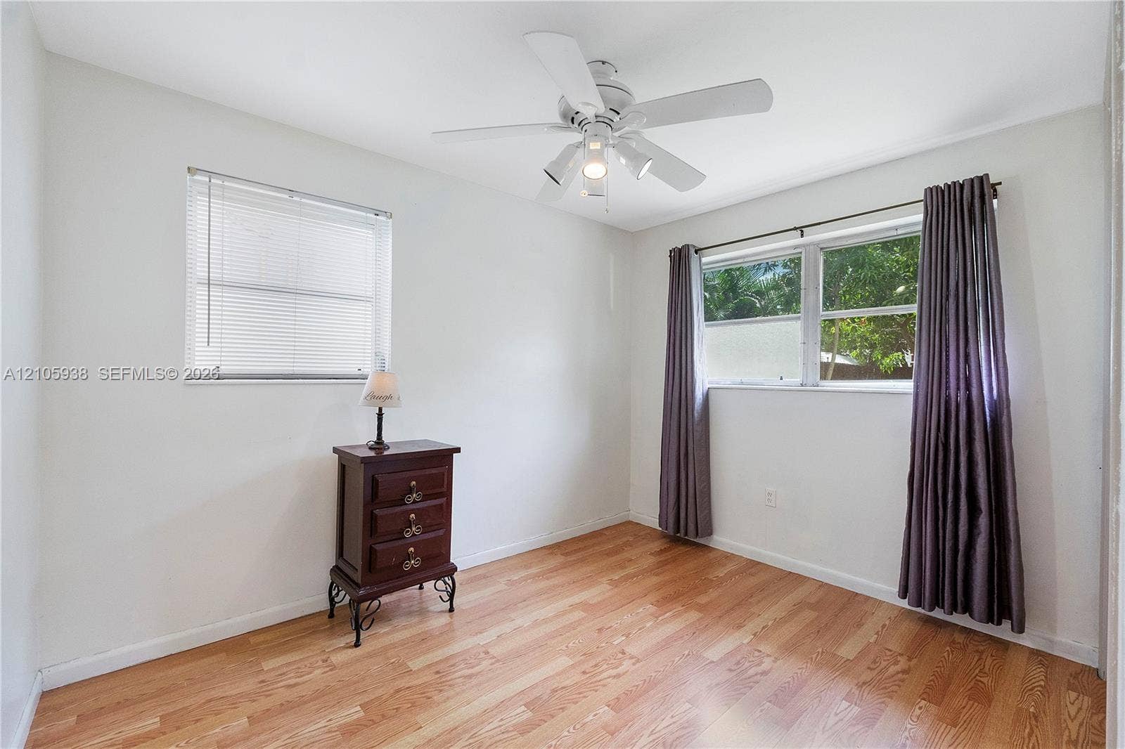 8310 NW 10th Street, Pembroke Pines, FL 33024 Interior space featuring wood-finish flooring, a neutral color palette, dual-pane windows, and a multi-light ceiling fan
