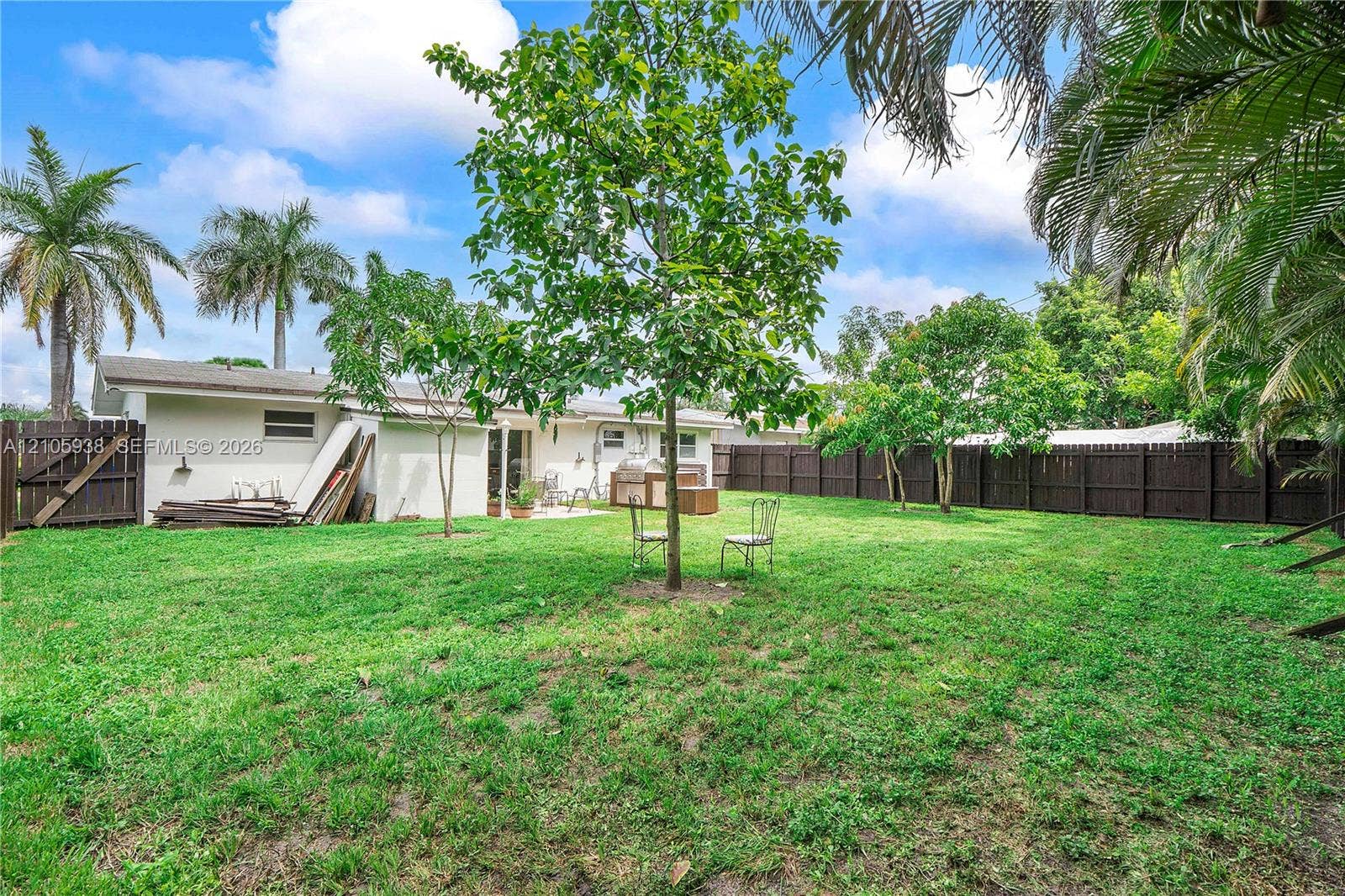 8310 NW 10th Street, Pembroke Pines, FL 33024 Expansive backyard featuring a fenced perimeter, mature trees, and open green space