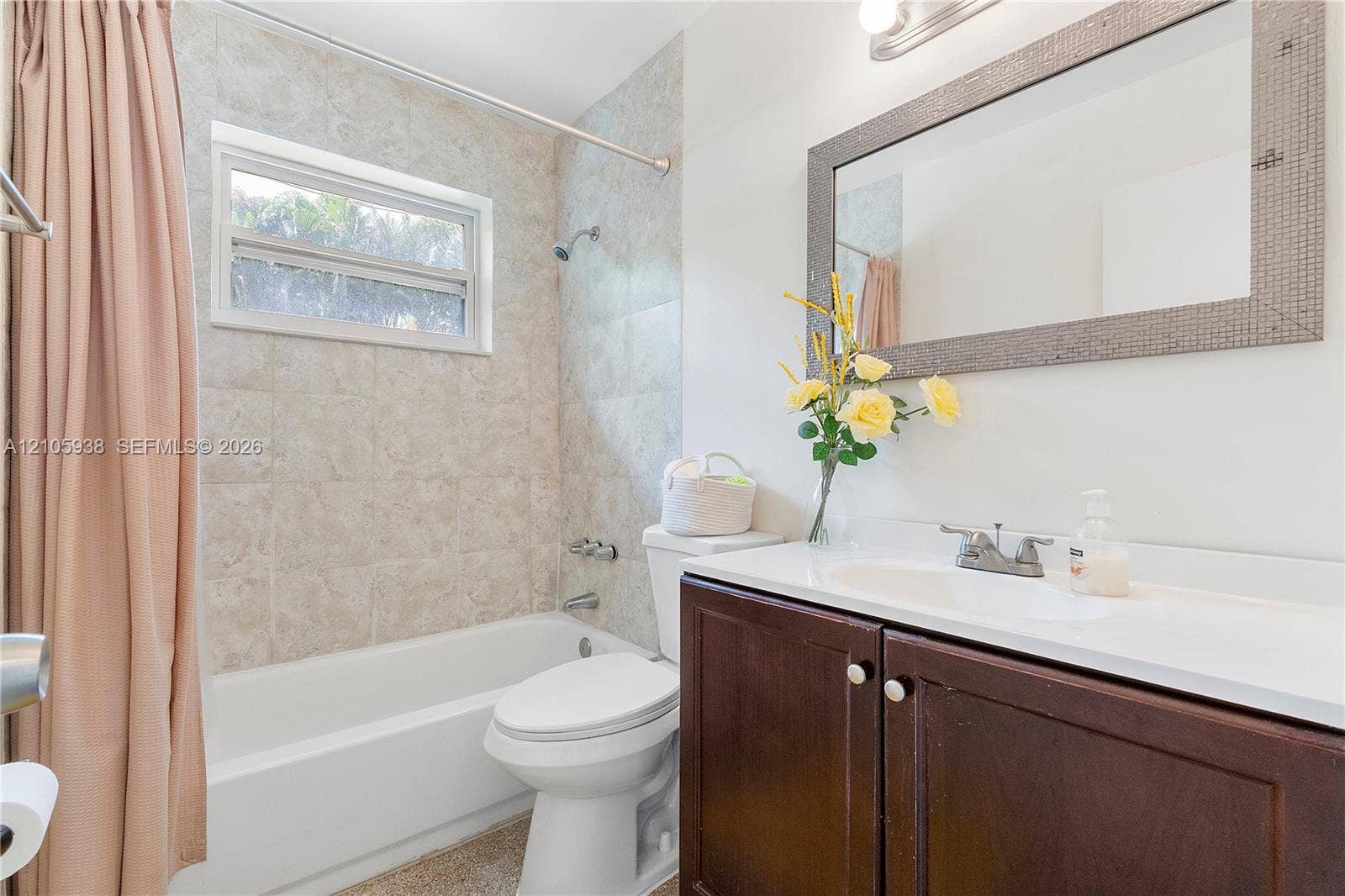 8310 NW 10th Street, Pembroke Pines, FL 33024 Bathroom featuring dark wood-finish cabinetry, a white countertop with an integrated sink, polished metal fixtures, and a shower-tub combination with neutral tile surround