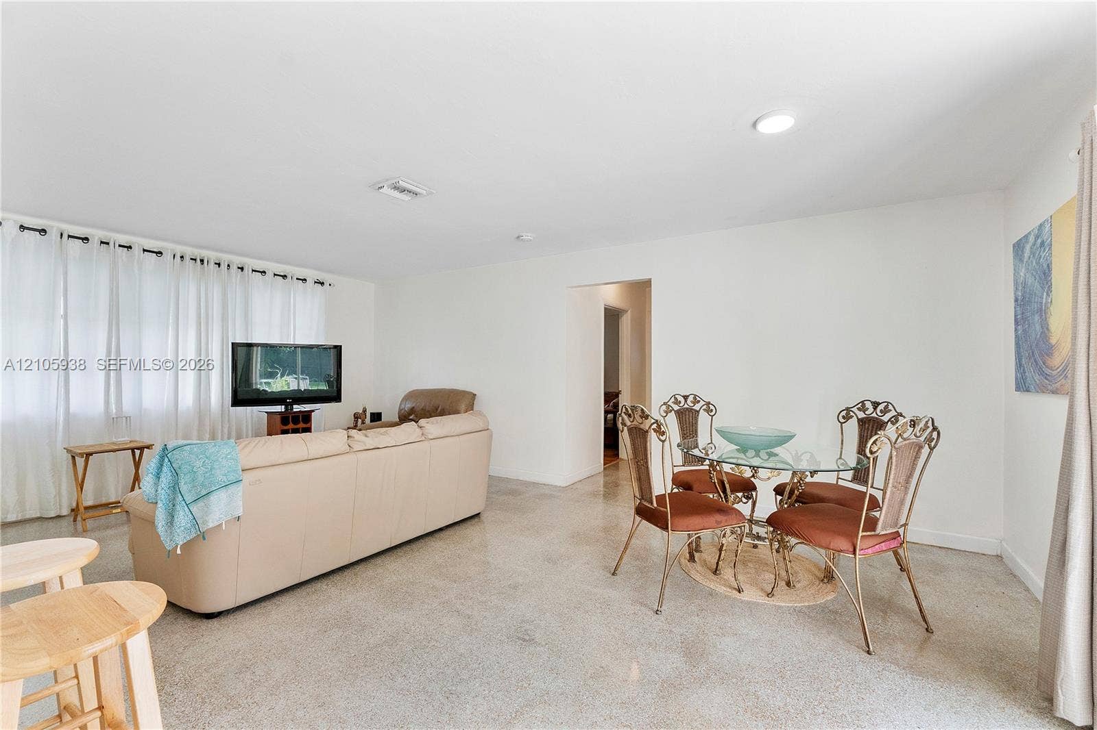 8310 NW 10th Street, Pembroke Pines, FL 33024 Open-concept interior featuring light-toned flooring, expansive windows with drapery, and recessed lighting