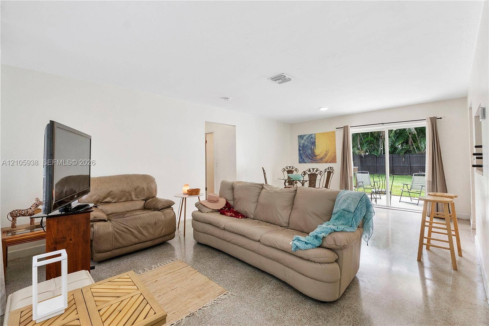 8310 NW 10th Street, Pembroke Pines, FL 33024 Polished concrete flooring, recessed lighting, and sliding glass doors providing outdoor access