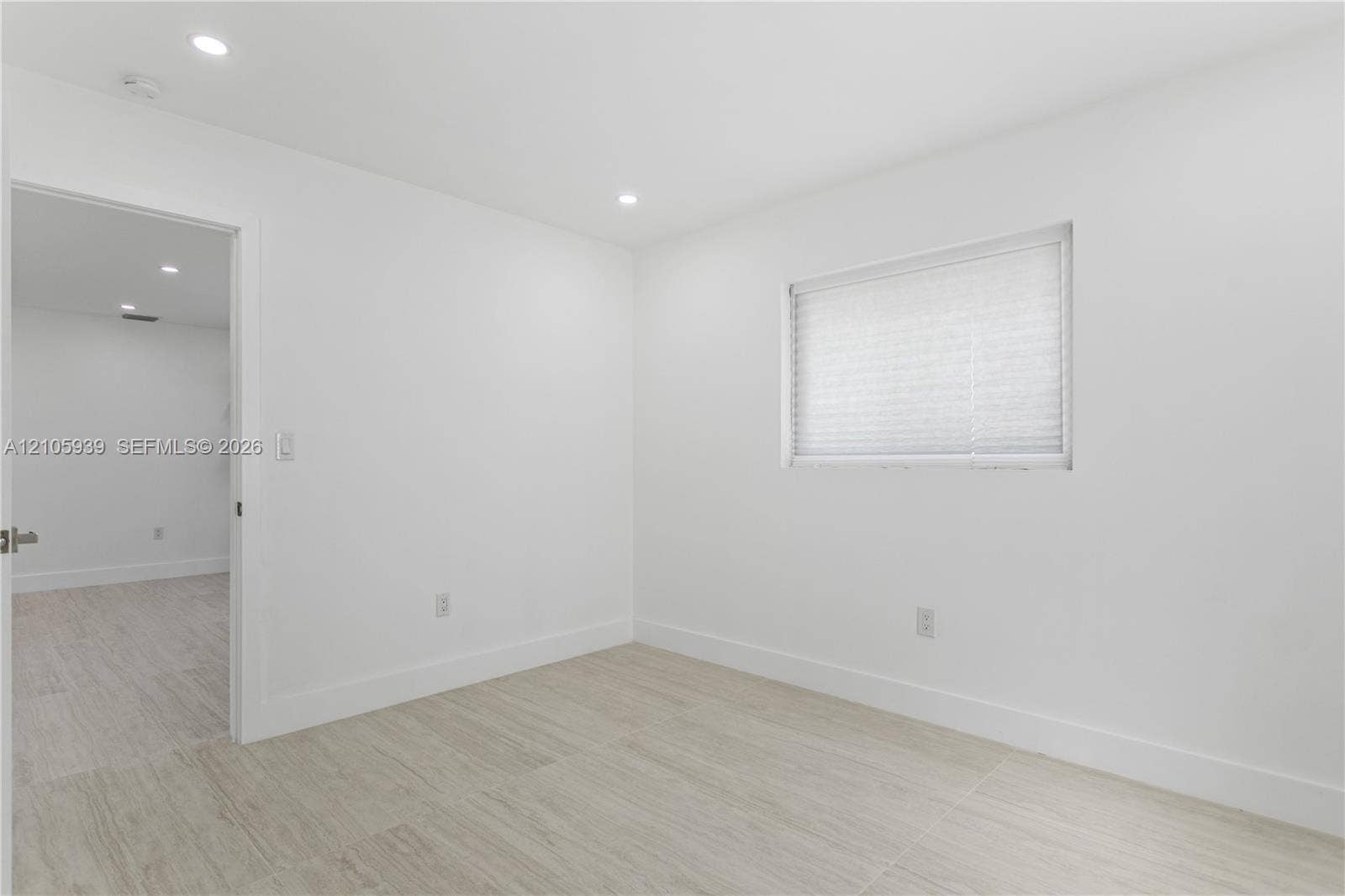 2850 NW 205th Street, Miami Gardens, FL 33056 Neutral interior featuring wood-finish flooring, recessed lighting, and a window with a pleated shade