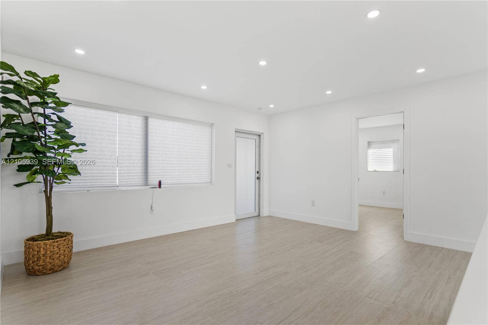 2850 NW 205th Street, Miami Gardens, FL 33056 Interior room featuring wood-finish flooring, recessed lighting, and a frosted glass exterior door