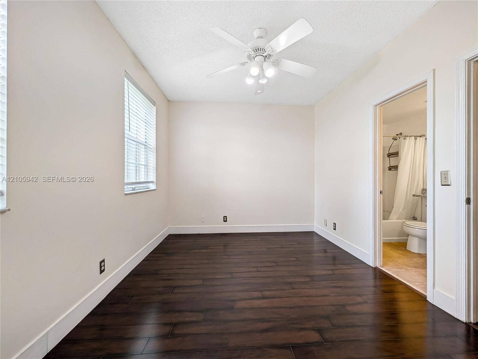 271 Duval Court, Weston, Weston, FL 33326 Room featuring dark wood-finish flooring, neutral wall tones, a ceiling fan with integrated lighting, and horizontal window blinds