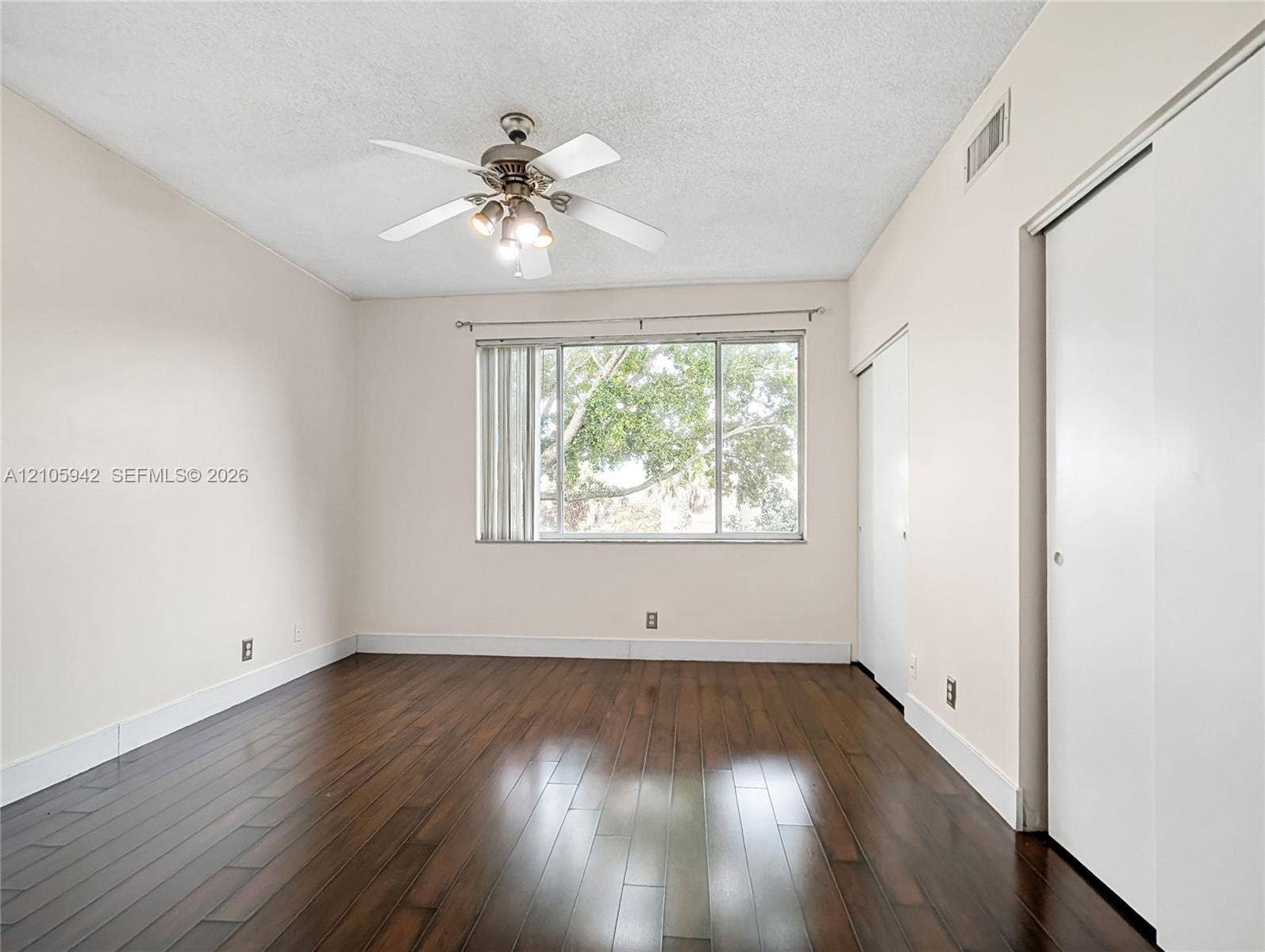 271 Duval Court, Weston, Weston, FL 33326 Room featuring wood-finish flooring, a ceiling fan with integrated lighting, and built-in sliding door closet storage