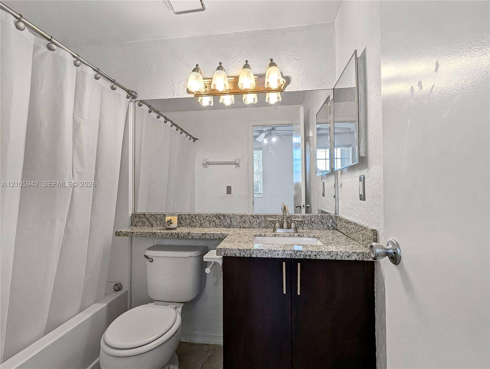 271 Duval Court, Weston, Weston, FL 33326 Bathroom featuring a vanity with stone-finish countertop, undermount sink, multi-light fixture, and large wall-mounted mirror