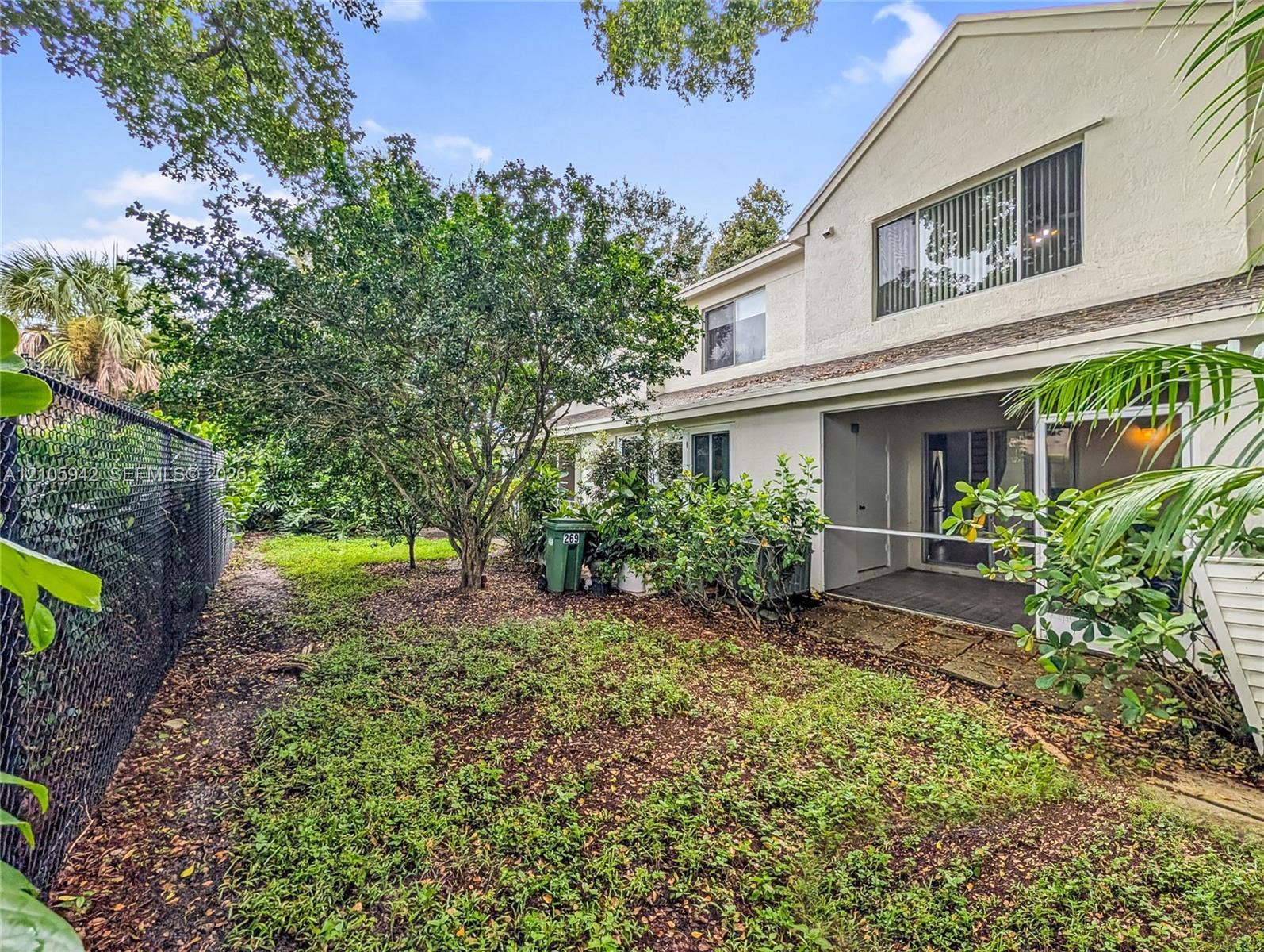 271 Duval Court, Weston, Weston, FL 33326 Rear exterior featuring a covered patio, stucco siding, multi-level design, and private chain-link fencing